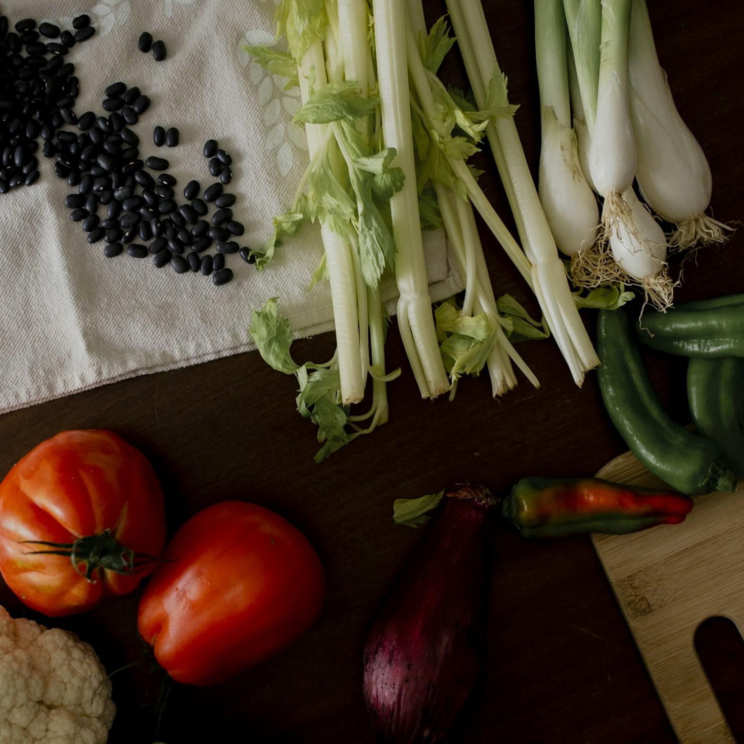 Community members collaborating in a modern kitchen space, sharing recipes and cooking techniques